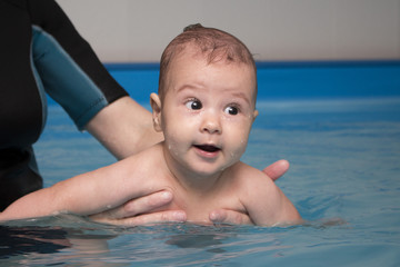 Small baby in the kids swimming pool