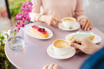 Sweet moments. Close up of delicious eclair and coffee proposing as lunch