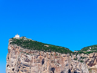 A beautiful view of the cliffs with the lighthouse Capo Caccia (Alghero). Sardinia, Italy