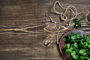 Fresh mint leaves on wooden background. Top view. Copy space
