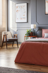 Poster in ginger bedroom interior