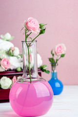 Flower arrangement with summer roses on a pink background