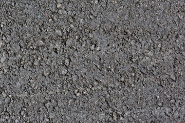 smooth grey asphalt pavement texture. heterogeneous structure of poor quality