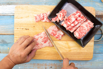 Chef slicing wagyu beef for cooking
