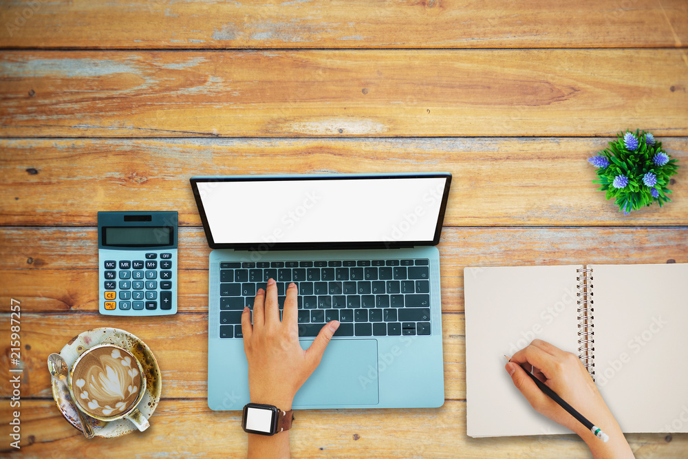 Poster a man is working by using a laptop computer on vintage wooden table. hands typing on a keyboard. top