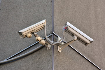 the surveillance camera on a wall of old building