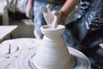 Ceramic dishes in working process. Creating ceramic pieces. Tradicional ceramic factory in spain. Father teaching the art of ceramic making.