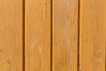Yellow wooden wall. Old shabby wooden planks with cracked color paint. Background. Texture wood.