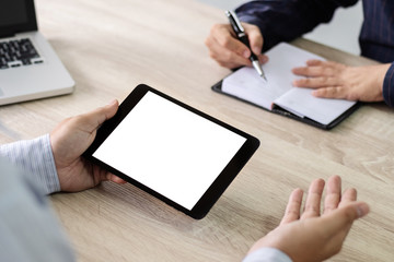 business colleagues using digital tablet discussing on investment value data in a meeting, blank screen background