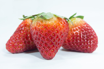 close up perfect red color strawberry . fresh fruits with green leaves , juicy ripe strawberries on white background