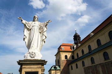 Fototapeta na wymiar Jesus Christ with open arms statue in front of Pilgrimage Basilica of the Assumption of the Virgin Mary and St. Cyril and Methodius at Velehrad Monastery, Moravia, Czech Republic