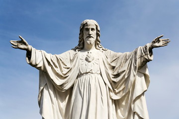 Fototapeta premium Jesus Christ with open arms statue in front of Pilgrimage Basilica of the Assumption of the Virgin Mary and St. Cyril and Methodius at Velehrad Monastery, Moravia, Czech Republic