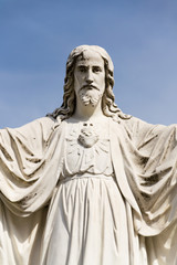 Fototapeta premium Jesus Christ with open arms statue in front of Pilgrimage Basilica of the Assumption of the Virgin Mary and St. Cyril and Methodius at Velehrad Monastery, Moravia, Czech Republic