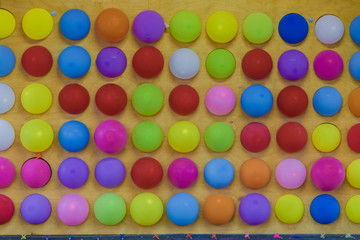 Colored balls on a wooden wall, new design.