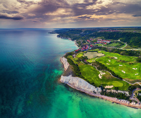 Aerial drone view of a golf course next to the cliffs and Black sea. Golfing fields landscape.
