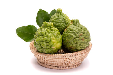 The kaffir lime leaves in the basket on a white background.