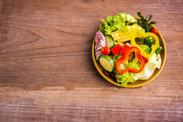 Fresh healthy salad on wood background. Weight loss. Slimming