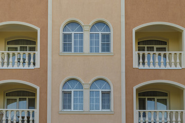 Wall of a house with windows in a classic design.