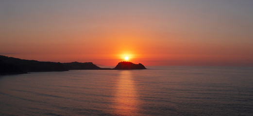 Island of San Anton and Cantabrian Sea at sunset in Getaria, Basque Country