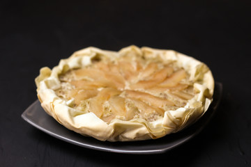 Apple cake with almond cream on a dark background. Baked cake. Casserole Cooked in multivarts Proper nutrition. Pie for the whole family on a sunny day