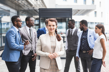 Portrait of an handsome businesswoman in front of his team. recognition, movement on the career ladder, success in business