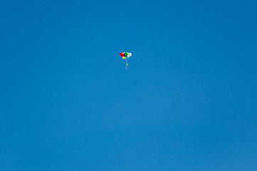 Background colorful balloons flying in the blue sky