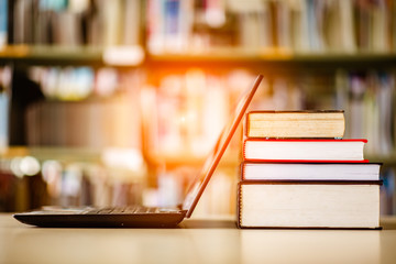 Bookshelves and laptops are placed on the library desk.