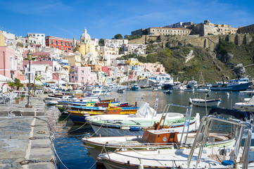Fototapeta na wymiar Beautiful view of traditional fishing boats moored in Corricella harbour on the island of Procida, Italy.
