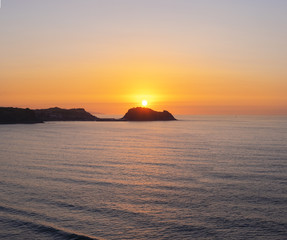 Fototapeta na wymiar Island of San Anton and Cantabrian Sea at sunset in Getaria, Basque Country
