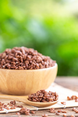 Breakfast cereal, Puffed rice with cocoa in bowl on wooden table with green blur space