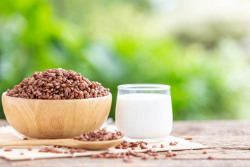 Breakfast cereal, Puffed rice with cocoa in bowl and glass of milk on wooden table