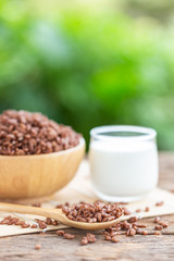 Breakfast cereal, Puffed rice with cocoa in bowl and glass of milk on wooden table