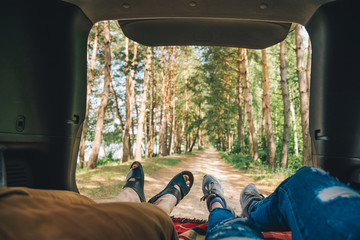 couple laying in suv trunk looking on forest. first person point of view © phpetrunina14