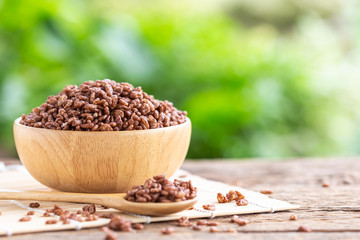 Breakfast cereal, Puffed rice with cocoa in bowl on wooden table with green blur space
