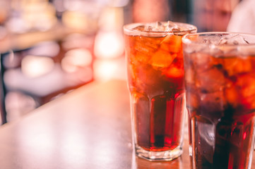 Fototapeta na wymiar Two glass soft drink with ice in restaurant background