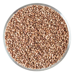Roasted buckwheat grains in glass bowl isolated on white background with clipping path