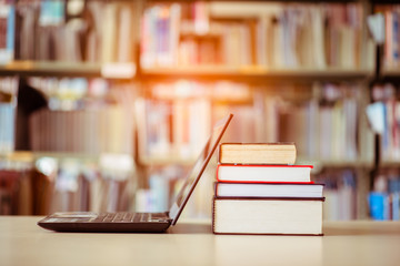 Bookshelves and laptops are placed on the library desk.