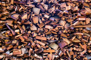Firewood wooden logs big chopped trunks stacked pile dry for used fireplace in winter.
