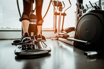Closeup leg of cardio workout on an elliptical.people working out on an elliptical trainer in...