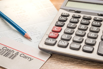 Calculator, cash card, pencil, bankbook Put on a wooden table.