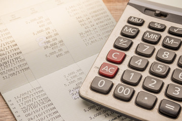 Calculator, bankbook Put on a wooden table.