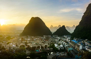 Foto op Canvas Sunrise in Yangshuo China over the karst rocks and city © creativefamily