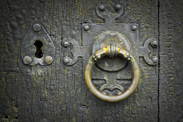old metalic latch on wooden door