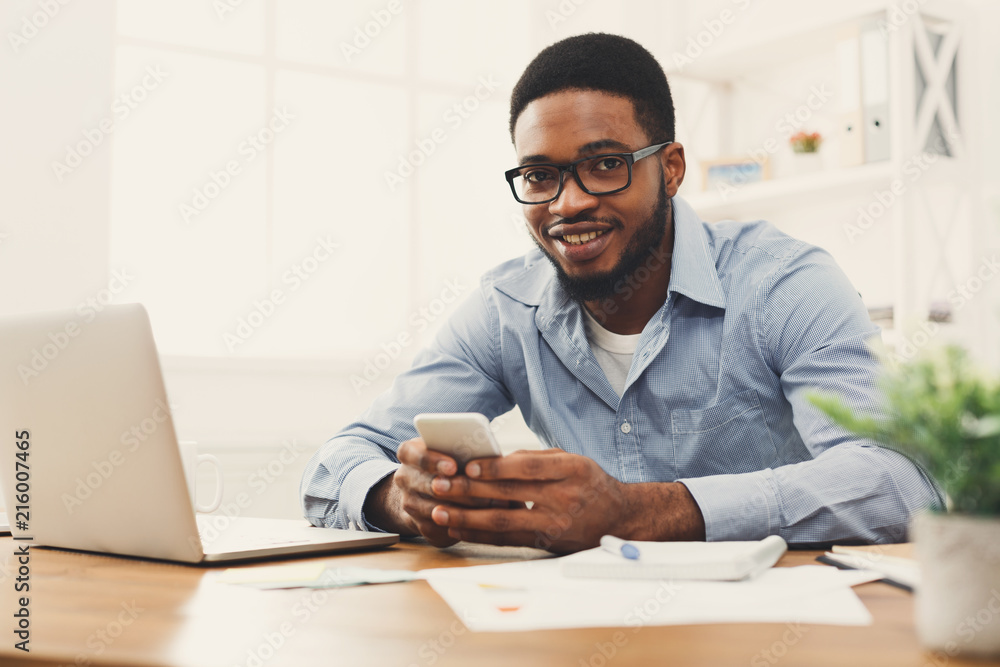 Poster young black businessman using mobile phone