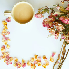 Picture of autumn background with dry roses and cup of coffee with copy space over white background