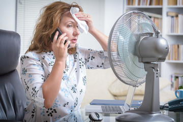 Woman suffers from heat in the office or at home