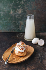 Choux pastry or choux cream or eclair dish on rustic background