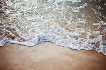 Soft wave on sandy beach. Background.