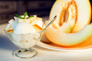 Vanilla ice cream with pieces of fresh melon close