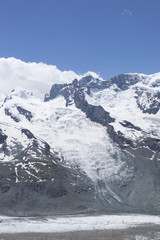 Fototapeta na wymiar Distant steep rocky snow-capped alpine summit in Valais - Swiss Alps